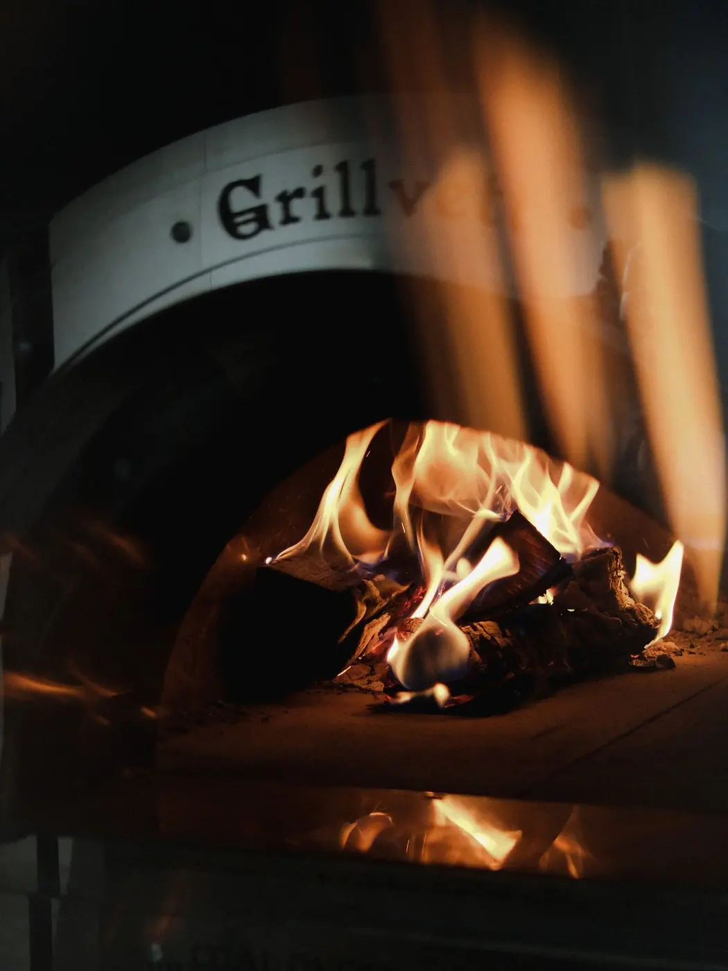 A small first fire burning in a newly built brick oven