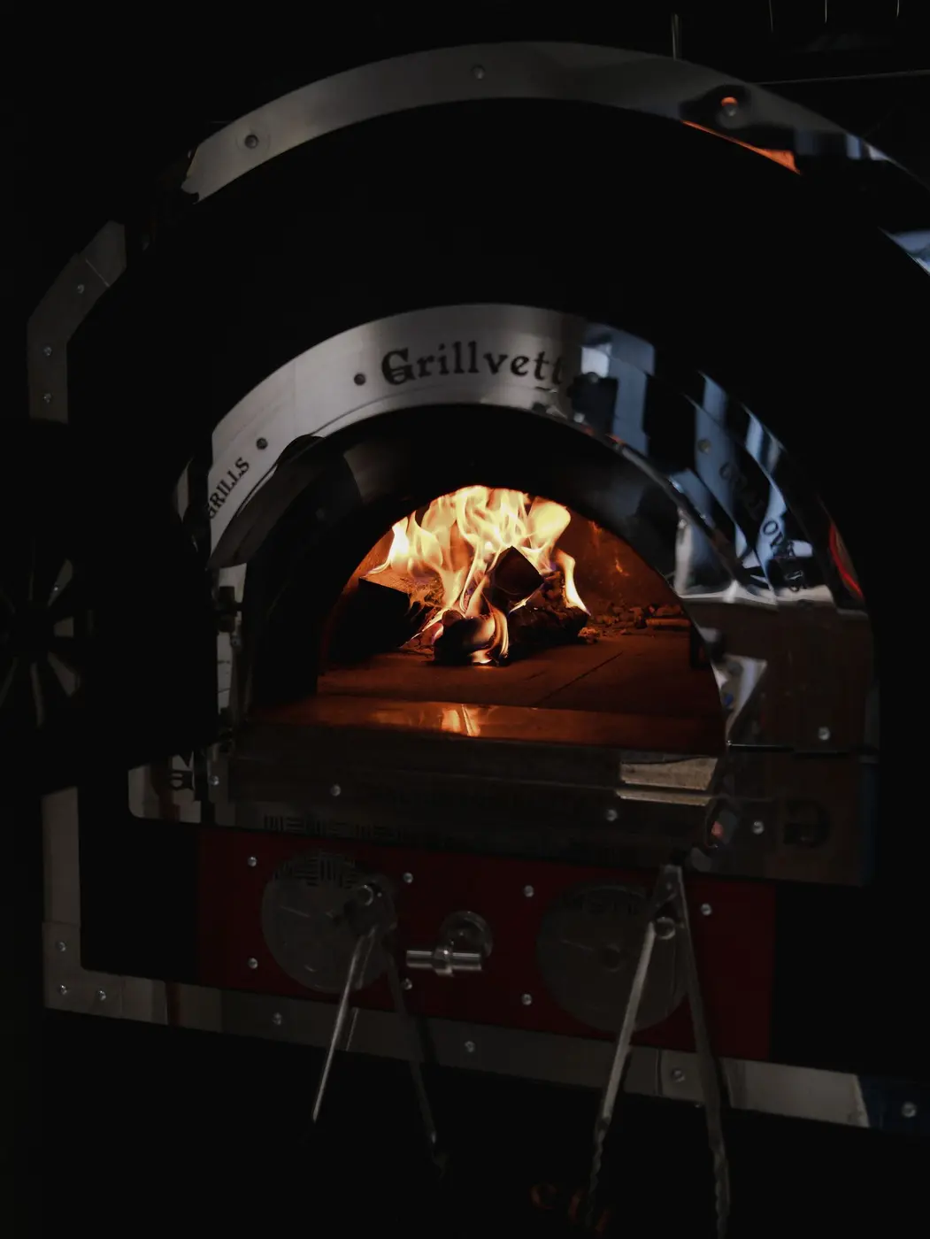 Flames burning inside the dome of a rustic wood-fired oven